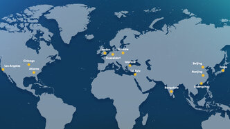 Illustrated world map with yellow markers highlighting major cities, including Los Angeles, Chicago, and Atlanta in the United States; London and Düsseldorf in Europe; Warsaw in Poland; Istanbul in Turkey; Tel Aviv in Israel; Bangalore in India; and Beijing, Nanjing, Guangzhou, and Tokyo in Asia, set against a dark blue ocean background.