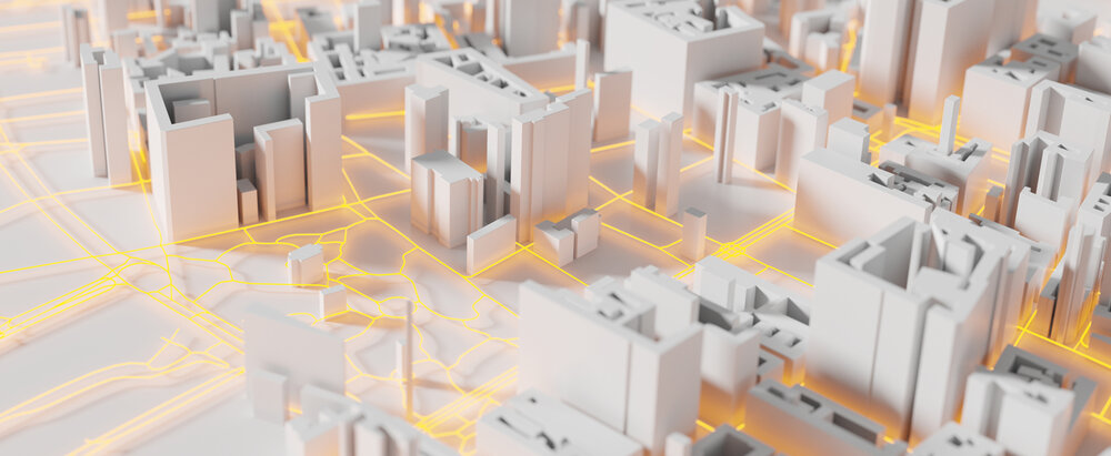 An abstract city model featuring white three-dimensional buildings and bright yellow lines representing roads and transport routes.