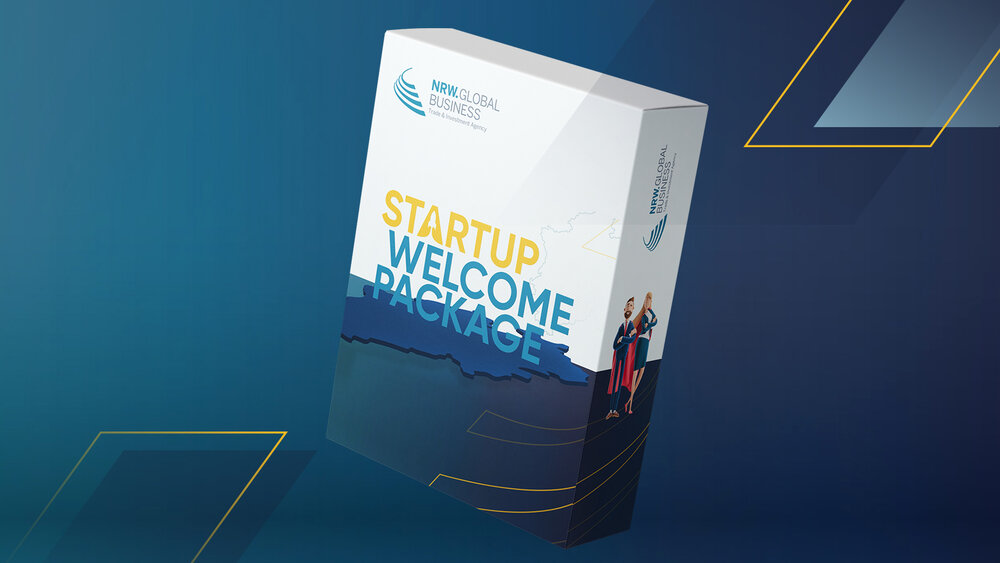 Box labeled 'STARTUP WELCOME PACKAGE' with NRW.Global Business logo and illustration of two people on the side